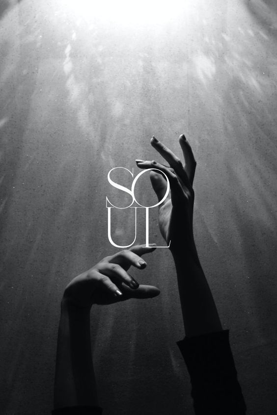 Black and white photograph of expressive hands reaching toward light